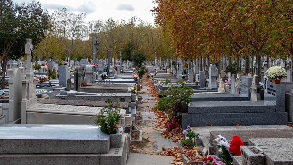 A family reviews granite headstone design options and paperwork at a table with sample materials and notebooks.